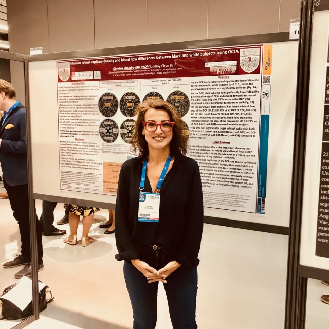 Dr. Dimitra Skondra in front of a Retina Research poster